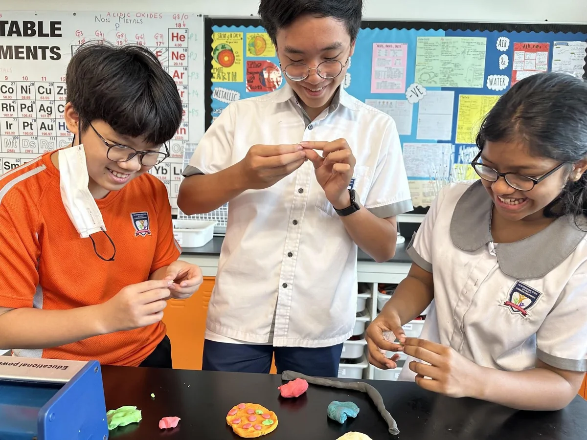 Students and an adult taking part in a hands-on activity at ISP